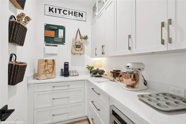 a kitchen with kitchen island stainless steel appliances a sink a stove and a wooden floor