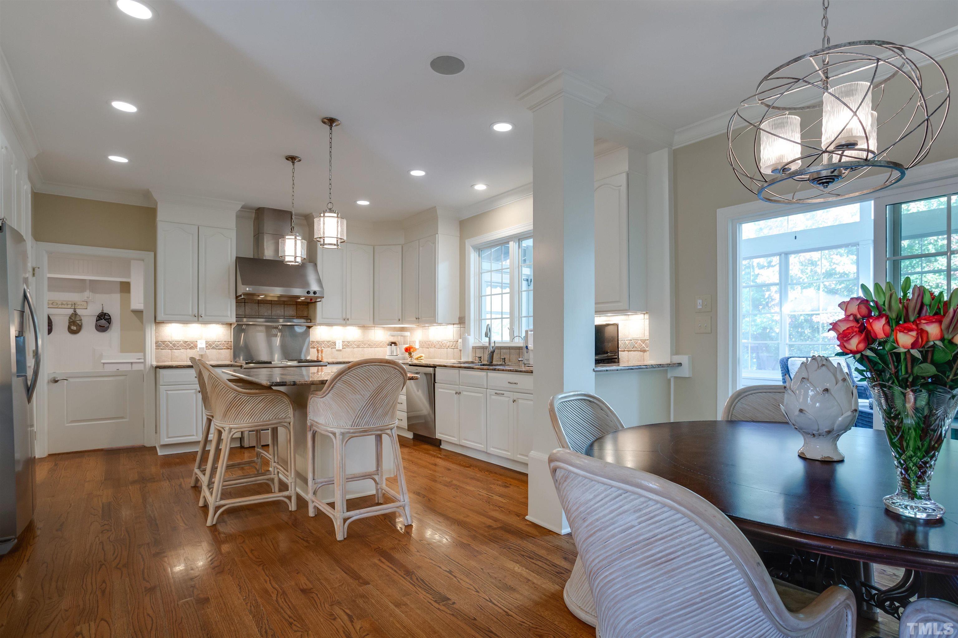 9004 Shellwood Court Raleigh, NC 27617 - Photo 12 of 30 a view of a dining room with furniture window and wooden floor
