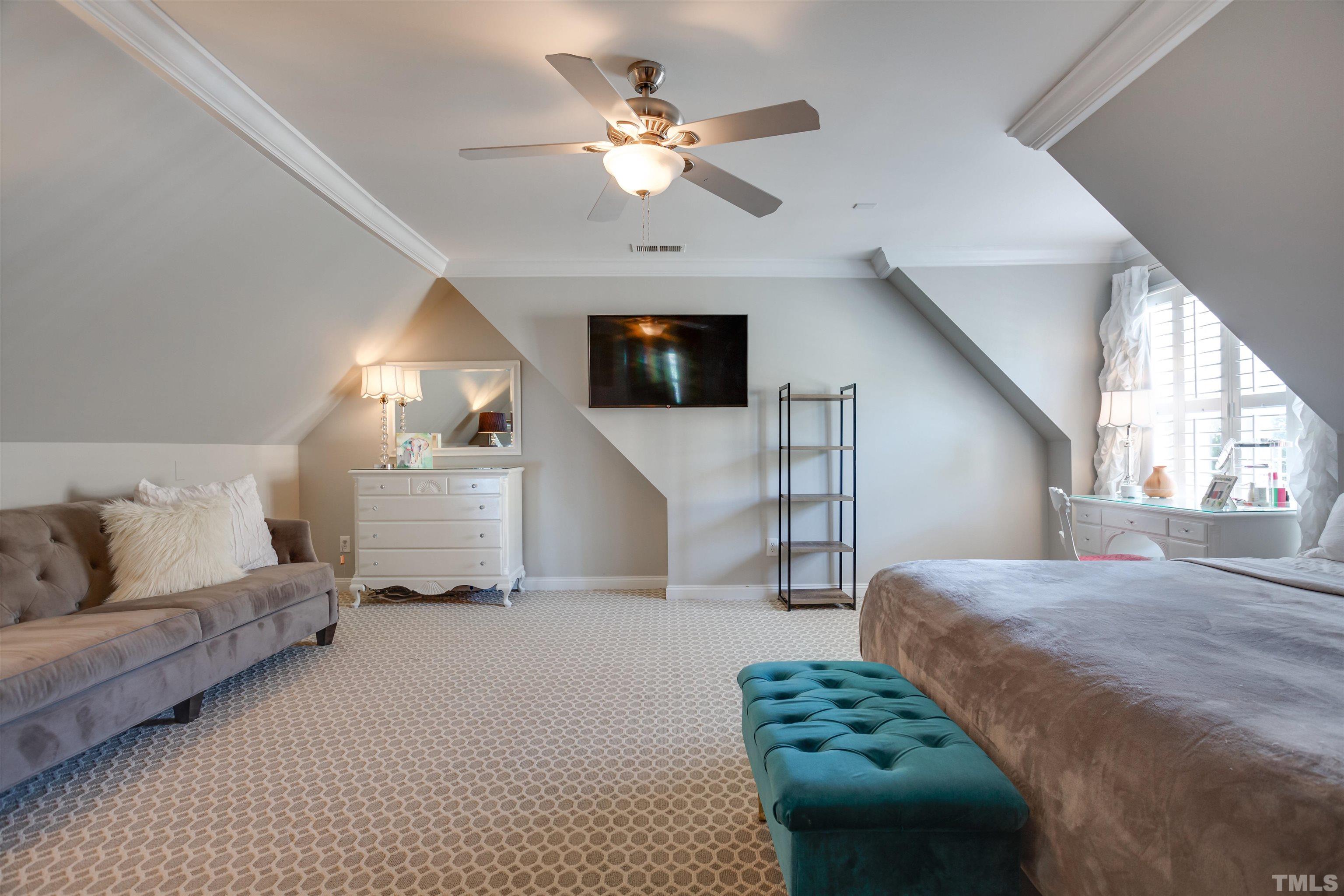 9004 Shellwood Court Raleigh, NC 27617 - Photo 18 of 30 a living room with furniture a ceiling fan and a flat screen tv