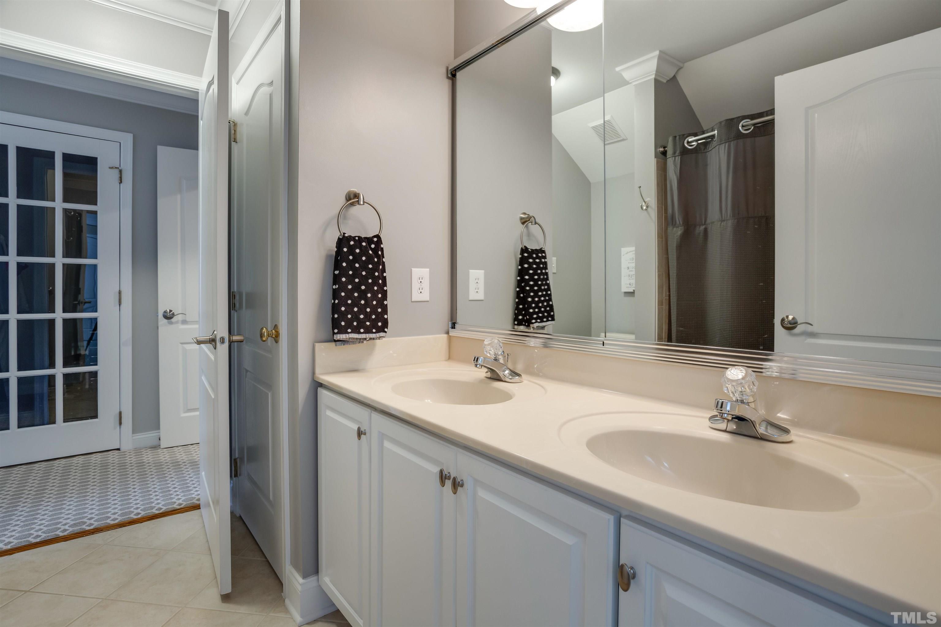 9004 Shellwood Court Raleigh, NC 27617 - Photo 19 of 30 a bathroom with a sink double vanity and a mirror