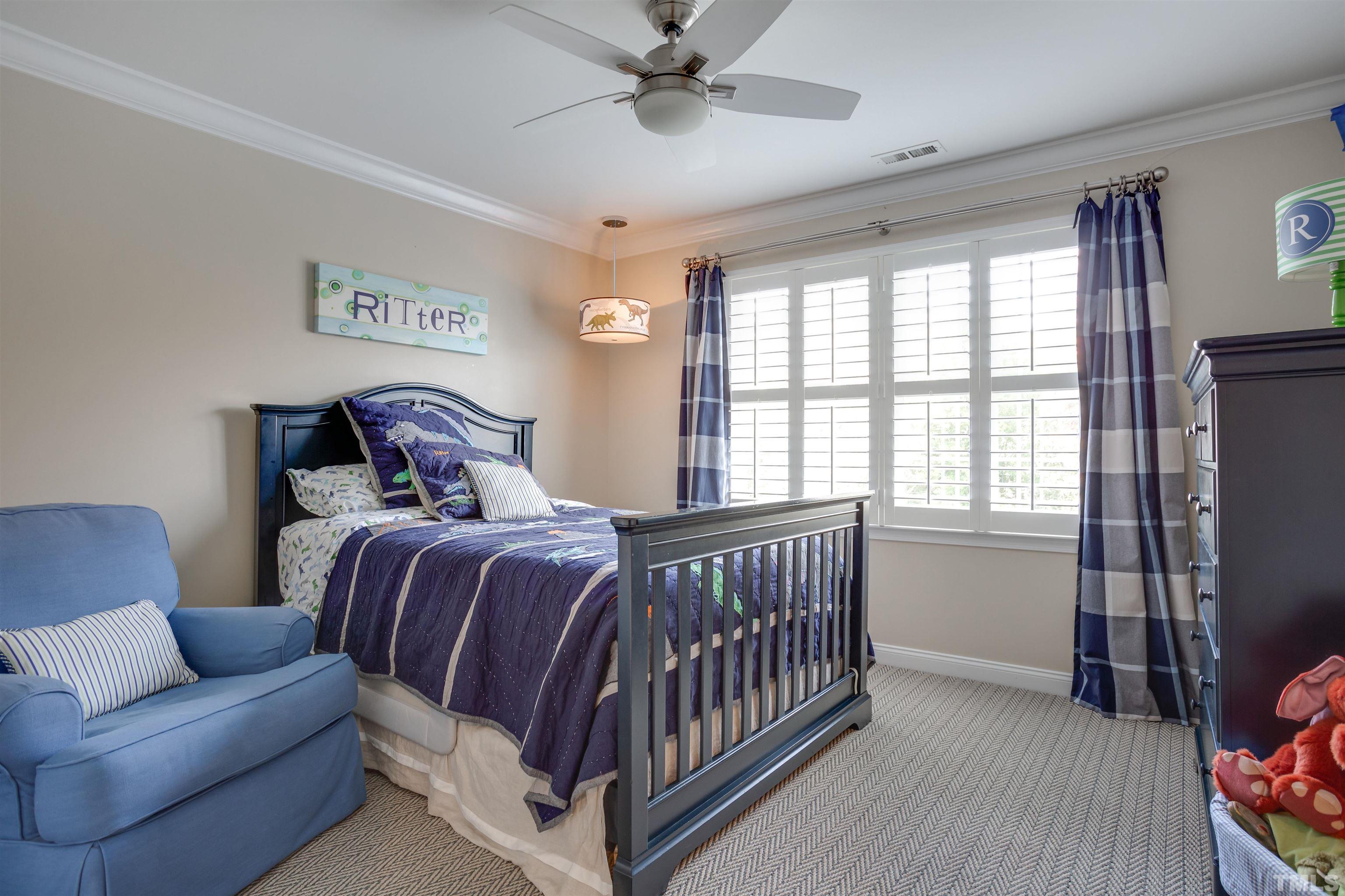 9004 Shellwood Court Raleigh, NC 27617 - Photo 20 of 30 a bedroom with a bed and a window