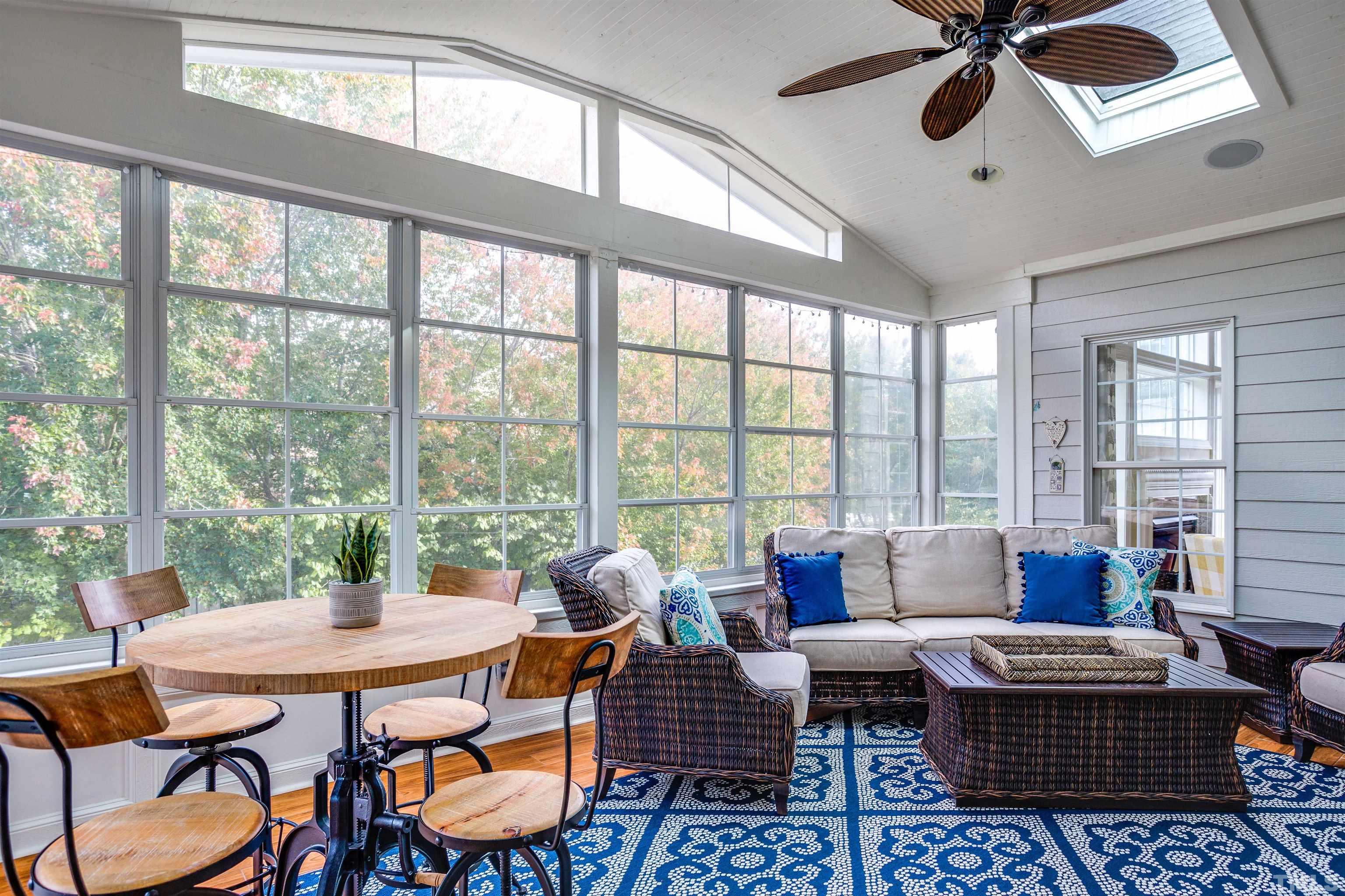 9004 Shellwood Court Raleigh, NC 27617 - Photo 22 of 30 a living room with furniture a ceiling fan and a floor to ceiling window
