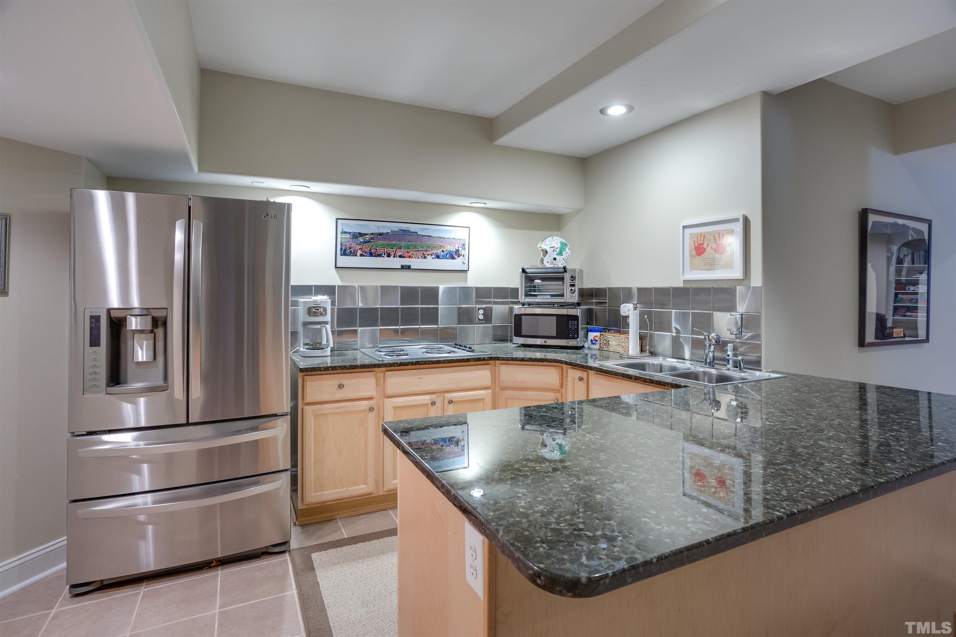 9004 Shellwood Court Raleigh, NC 27617 - Photo 23 of 30 a kitchen with stainless steel appliances granite countertop a sink and a refrigerator