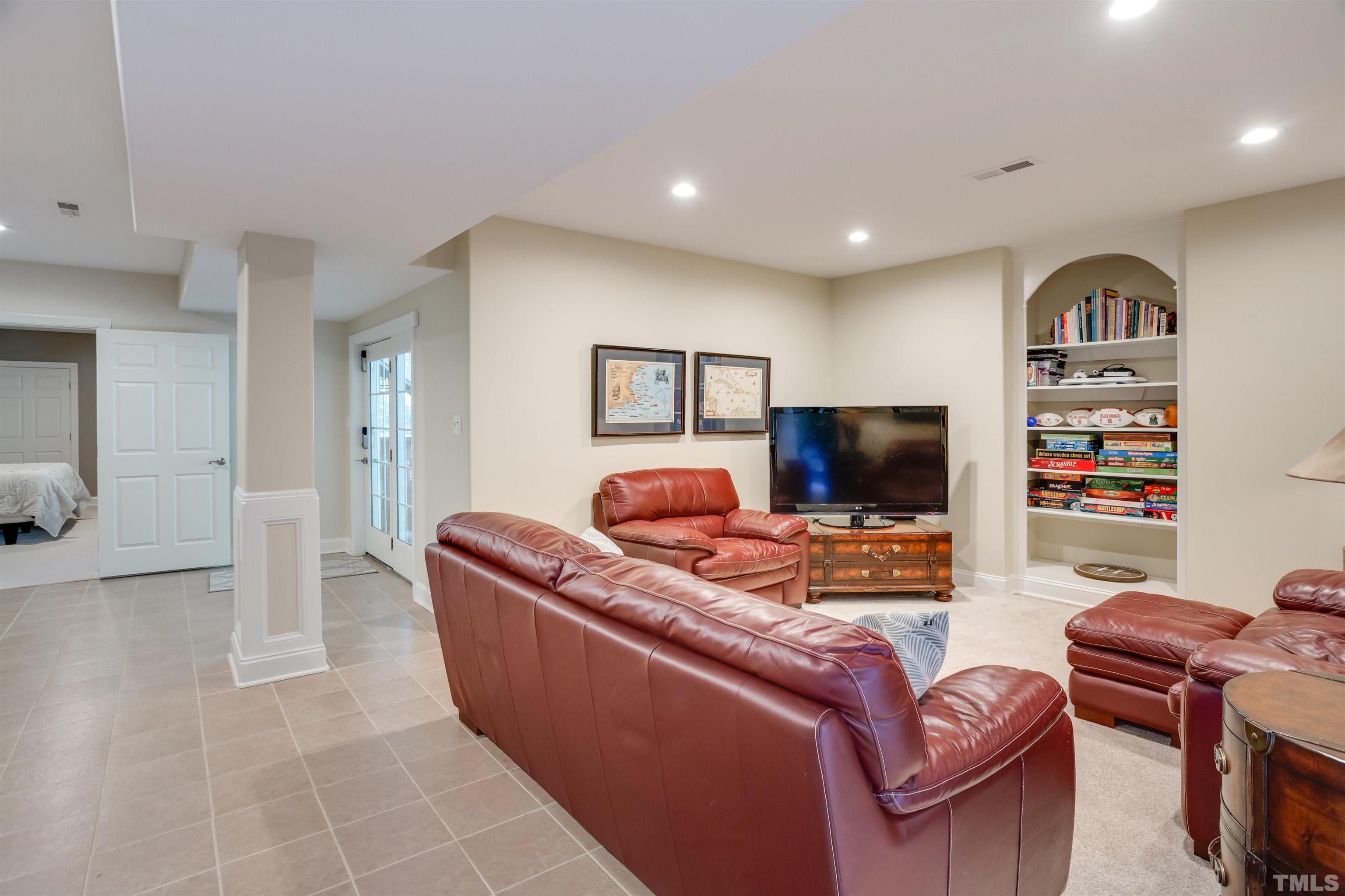9004 Shellwood Court Raleigh, NC 27617 - Photo 24 of 30 a living room with furniture and a flat screen tv