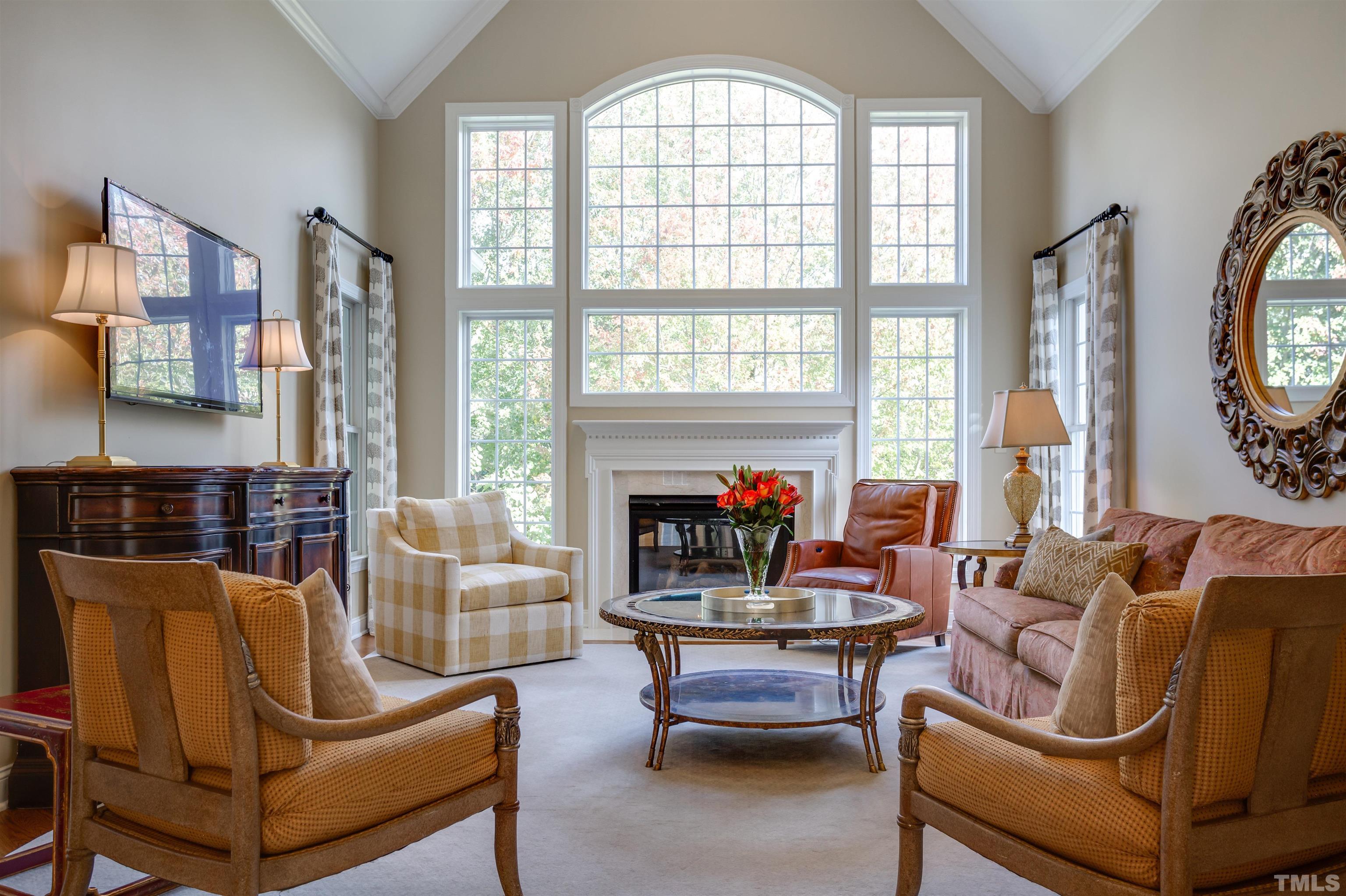 9004 Shellwood Court Raleigh, NC 27617 - Photo 5 of 30 a living room with furniture a fireplace and a large window