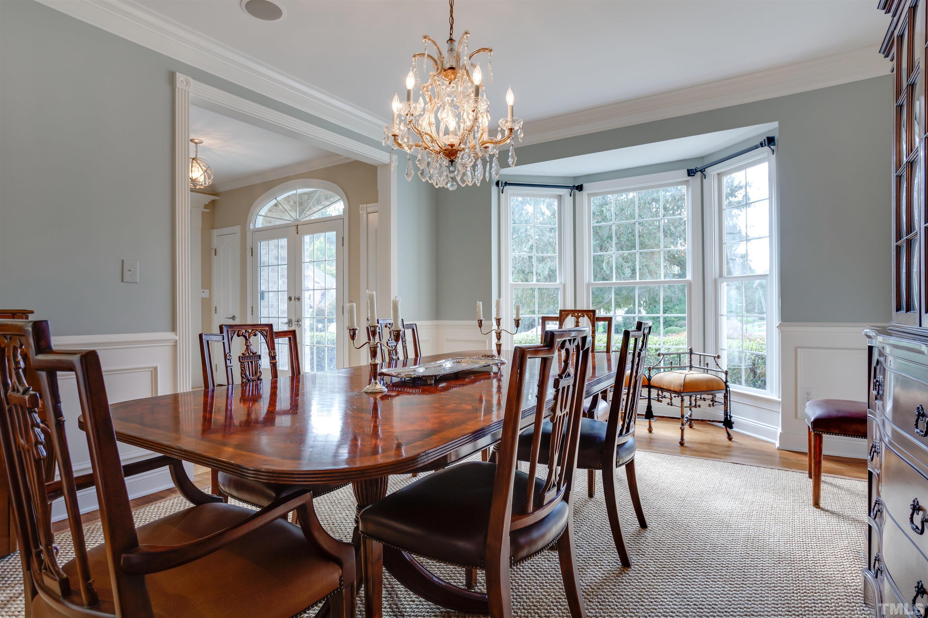 9004 Shellwood Court Raleigh, NC 27617 - Photo 8 of 30 a view of a dining room with furniture a chandelier and large windows