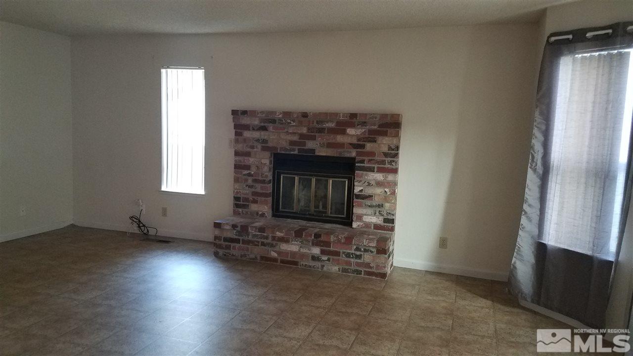 2620 Keystone Avenue Reno, NV 89503 - Photo 3 of 34 an empty room with windows fire place and a fireplace