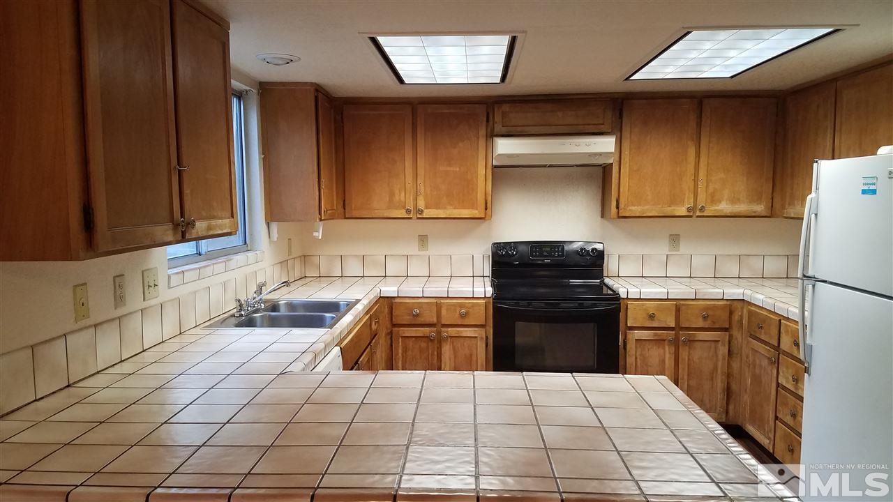 2620 Keystone Avenue Reno, NV 89503 - Photo 9 of 34 a kitchen with granite countertop a stove a sink and a refrigerator