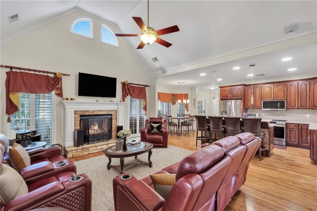 211 Graymist Path Southwest Loganville, GA 30052 - Photo 11 of 65 a living room with furniture a fireplace and a flat screen tv