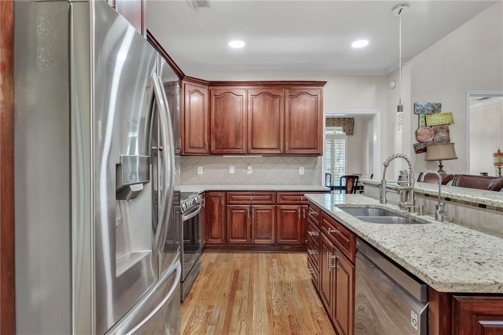 211 Graymist Path Southwest Loganville, GA 30052 - Photo 17 of 65 a kitchen with stainless steel appliances granite countertop a sink stove and refrigerator