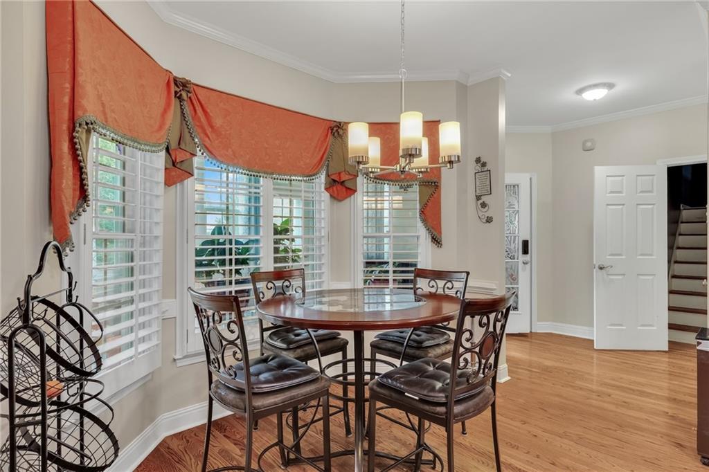 211 Graymist Path Southwest Loganville, GA 30052 - Photo 18 of 65 a view of a dining room and livingroom with furniture wooden floor a chandelier