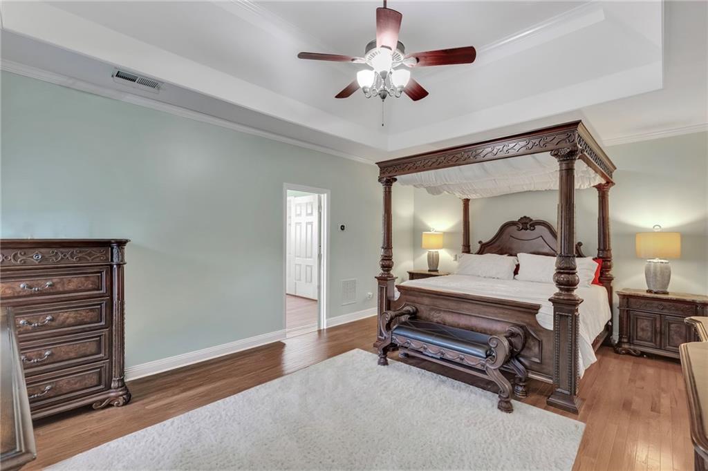 211 Graymist Path Southwest Loganville, GA 30052 - Photo 20 of 65 a spacious bedroom with a bed and a chandelier