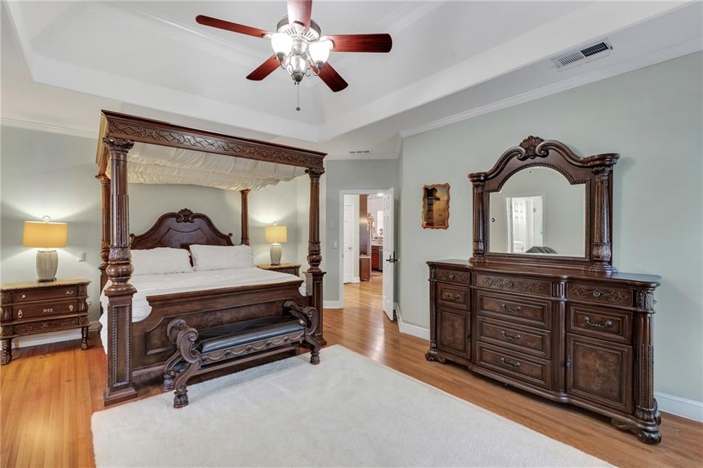 211 Graymist Path Southwest Loganville, GA 30052 - Photo 21 of 65 a bedroom with a bed and a chandelier