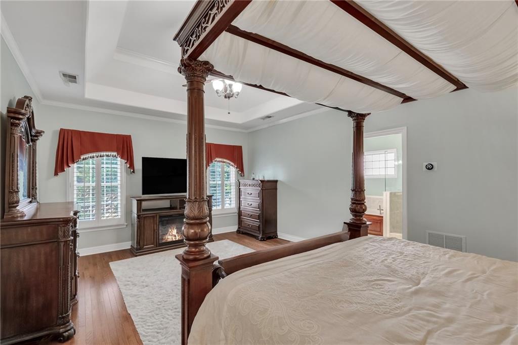 211 Graymist Path Southwest Loganville, GA 30052 - Photo 22 of 65 a bedroom with bed and flat screen tv