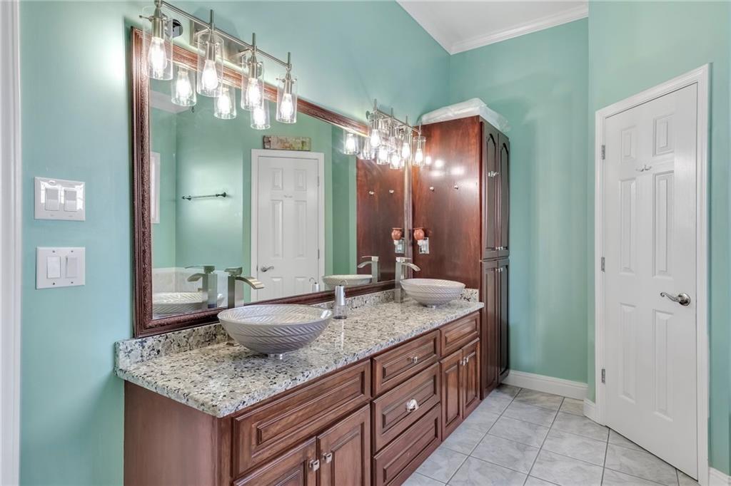 211 Graymist Path Southwest Loganville, GA 30052 - Photo 24 of 65 a bathroom with a granite countertop sink and a mirror