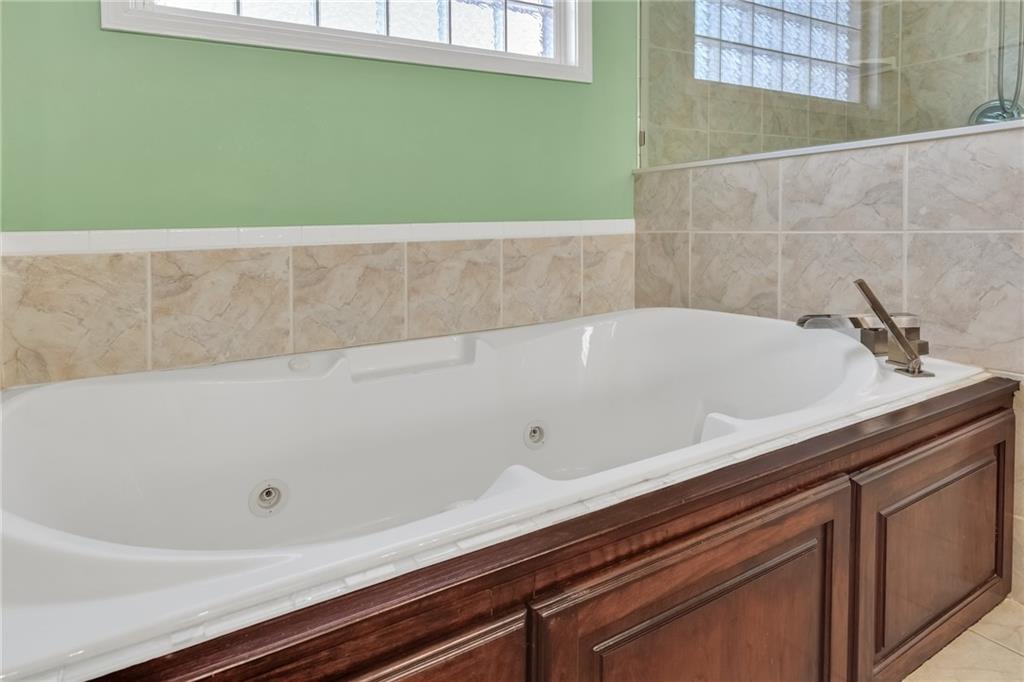 211 Graymist Path Southwest Loganville, GA 30052 - Photo 27 of 65 a bathroom with a bathtub and sink
