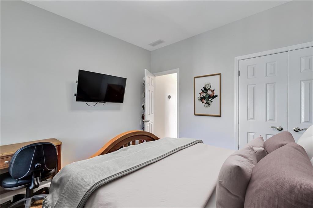 211 Graymist Path Southwest Loganville, GA 30052 - Photo 29 of 65 a bedroom with a bed and a flat screen tv