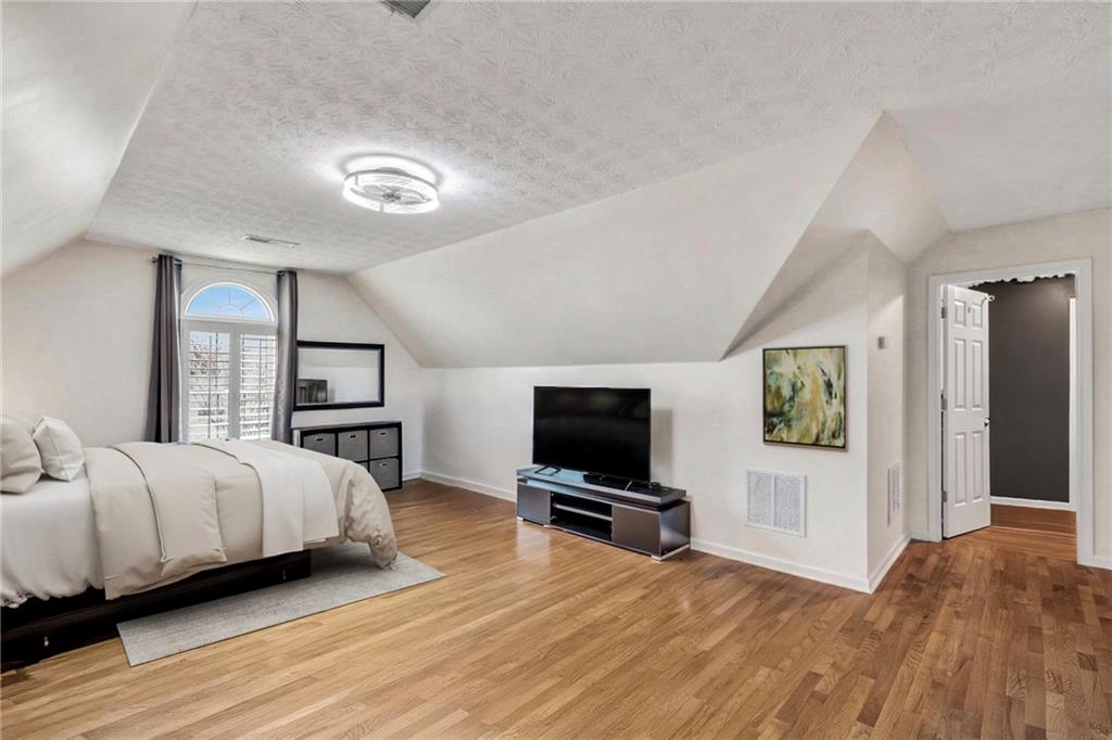 211 Graymist Path Southwest Loganville, GA 30052 - Photo 34 of 65 a bedroom with a bed and a flat screen tv