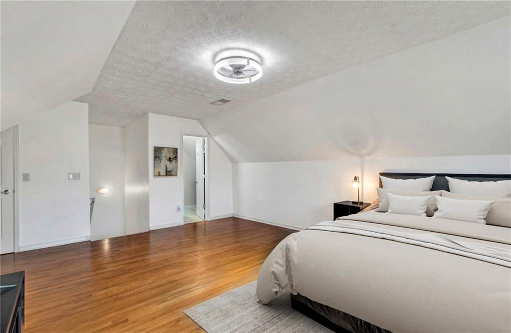 211 Graymist Path Southwest Loganville, GA 30052 - Photo 35 of 65 a bedroom with bed and a night stand