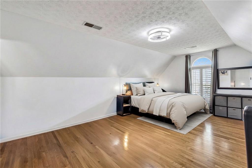 211 Graymist Path Southwest Loganville, GA 30052 - Photo 36 of 65 a bedroom with a bed and a lamp on dresser