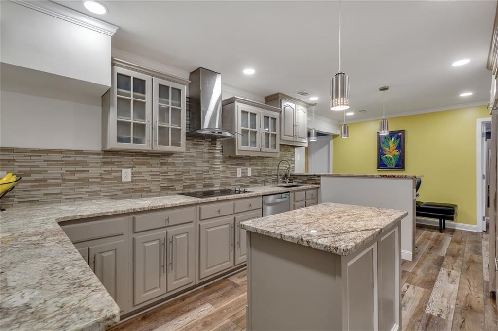 211 Graymist Path Southwest Loganville, GA 30052 - Photo 42 of 65 a kitchen with stainless steel appliances granite countertop a kitchen island a stove and a sink