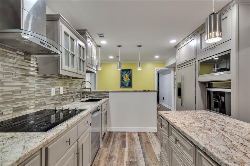 211 Graymist Path Southwest Loganville, GA 30052 - Photo 43 of 65 a kitchen with stainless steel appliances granite countertop a stove and a sink