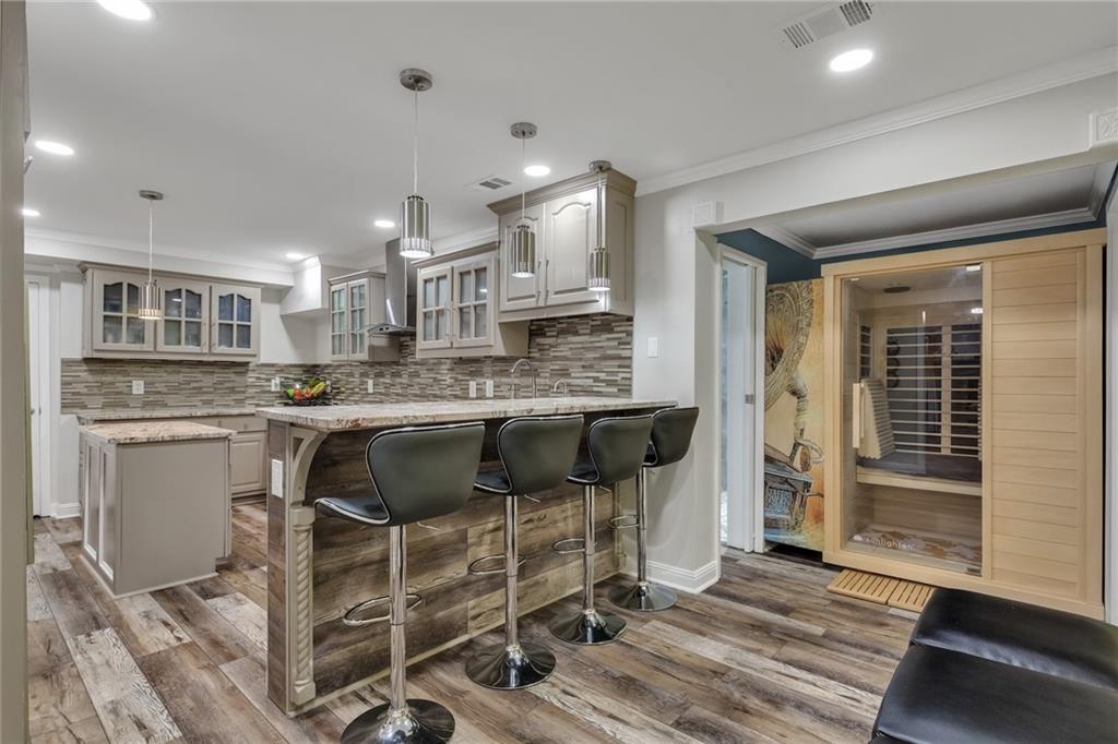 211 Graymist Path Southwest Loganville, GA 30052 - Photo 45 of 65 a kitchen with a table chairs refrigerator and cabinets