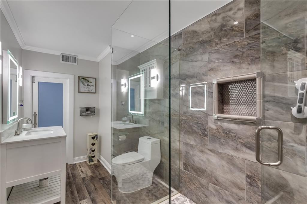 211 Graymist Path Southwest Loganville, GA 30052 - Photo 48 of 65 a bathroom with a granite countertop sink a toilet and shower