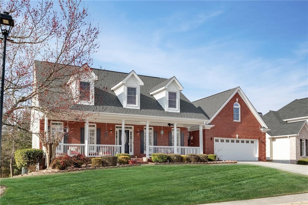 211 Graymist Path Southwest Loganville, GA 30052 - Photo 5 of 65 a front view of a house with a yard garden and plants