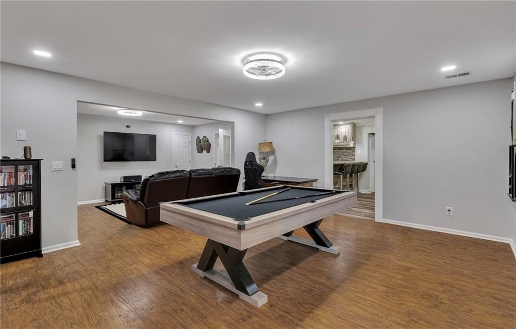 211 Graymist Path Southwest Loganville, GA 30052 - Photo 51 of 65 a living room with furniture flat screen tv and gym equipment
