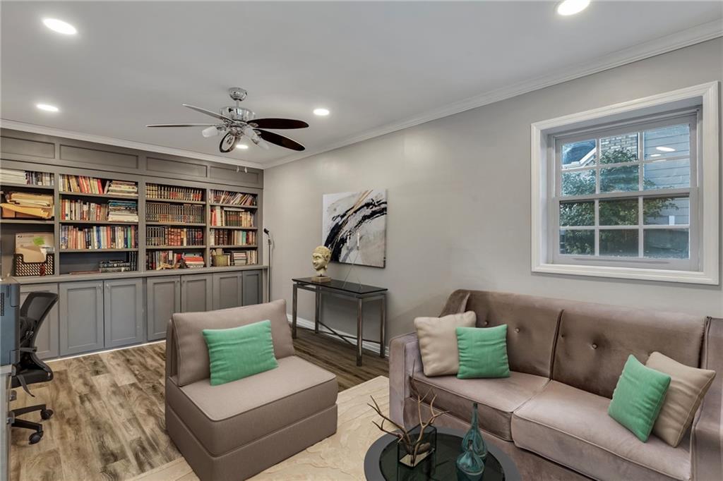 211 Graymist Path Southwest Loganville, GA 30052 - Photo 52 of 65 a living room with furniture and a book shelf