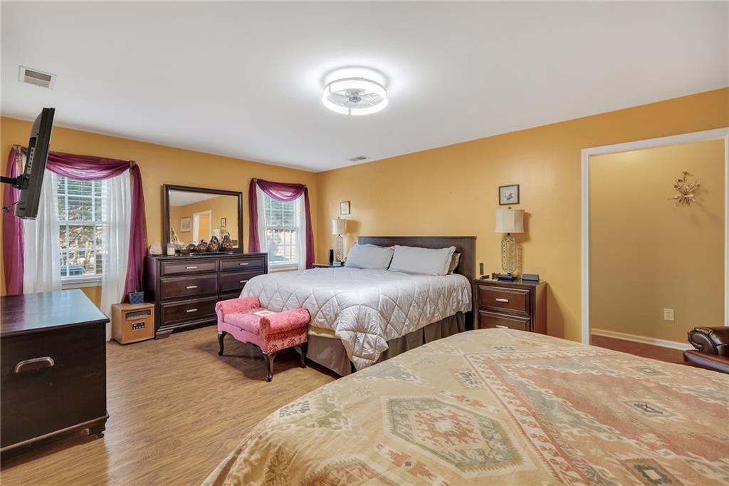 211 Graymist Path Southwest Loganville, GA 30052 - Photo 53 of 65 a bedroom with a bed and wooden floor