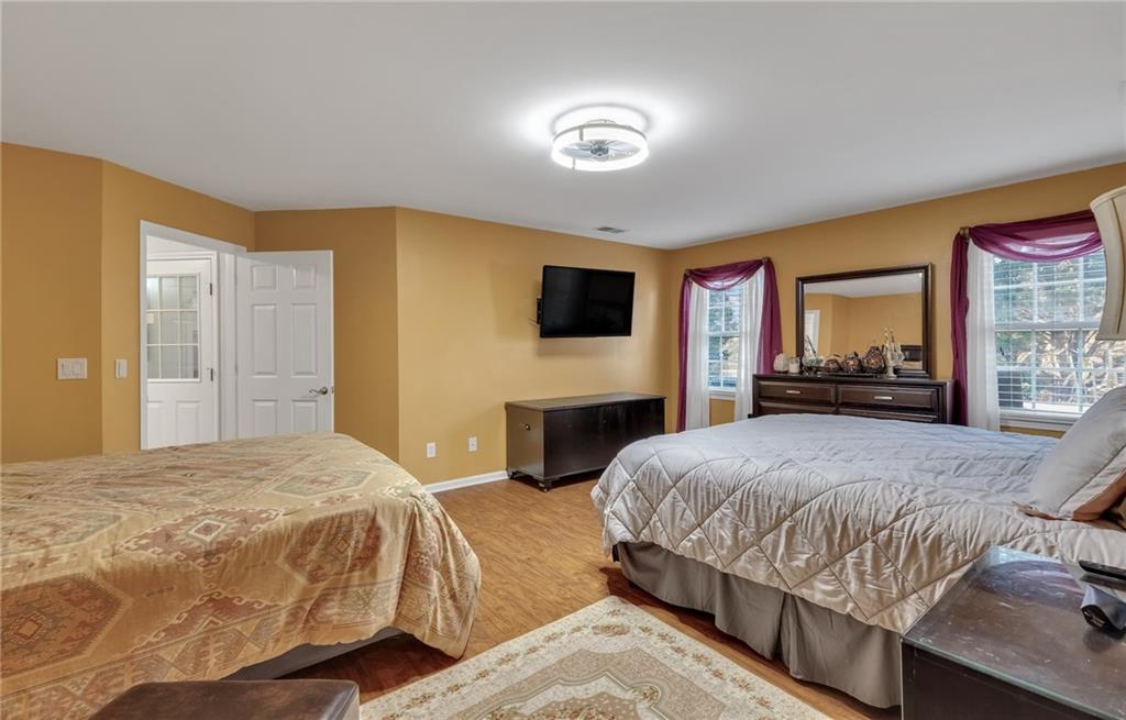 211 Graymist Path Southwest Loganville, GA 30052 - Photo 55 of 65 a bedroom with a bed and a flat screen tv