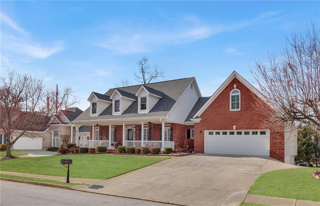 211 Graymist Path Southwest Loganville, GA 30052 - Photo 6 of 65 a view of a big house with a big yard and large trees