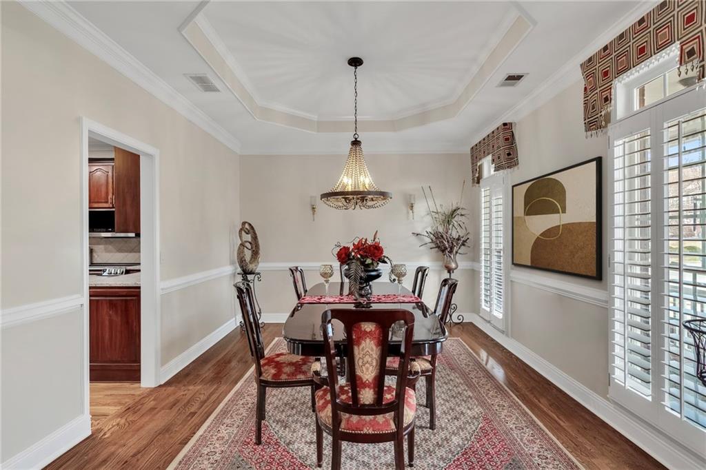 211 Graymist Path Southwest Loganville, GA 30052 - Photo 9 of 65 a dining room with furniture a chandelier and wooden floor