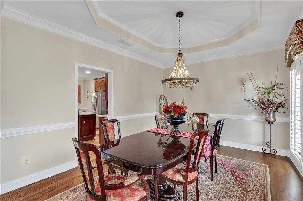 211 Graymist Path Southwest Loganville, GA 30052 - Photo 10 of 65 a view of a dining room with furniture and wooden floor