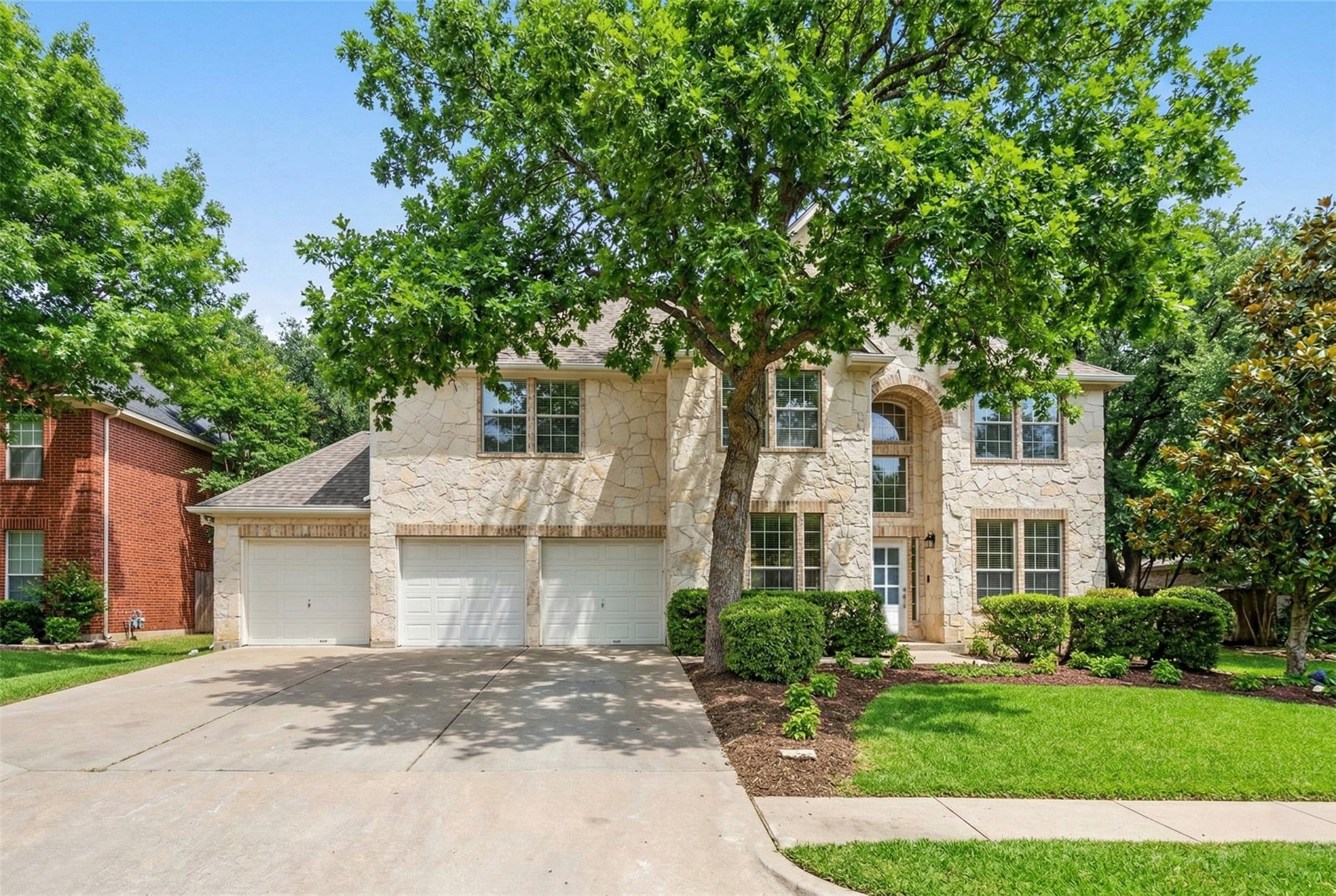 2022 Inverness Drive Round Rock, TX 78681 - Photo 2 of 38 a front view of a house with a garden
