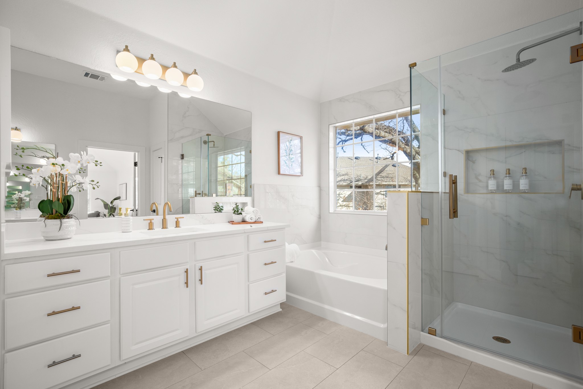 2022 Inverness Drive Round Rock, TX 78681 - Photo 24 of 38 a spacious bathroom with a double vanity sink a mirror a glass door and shower