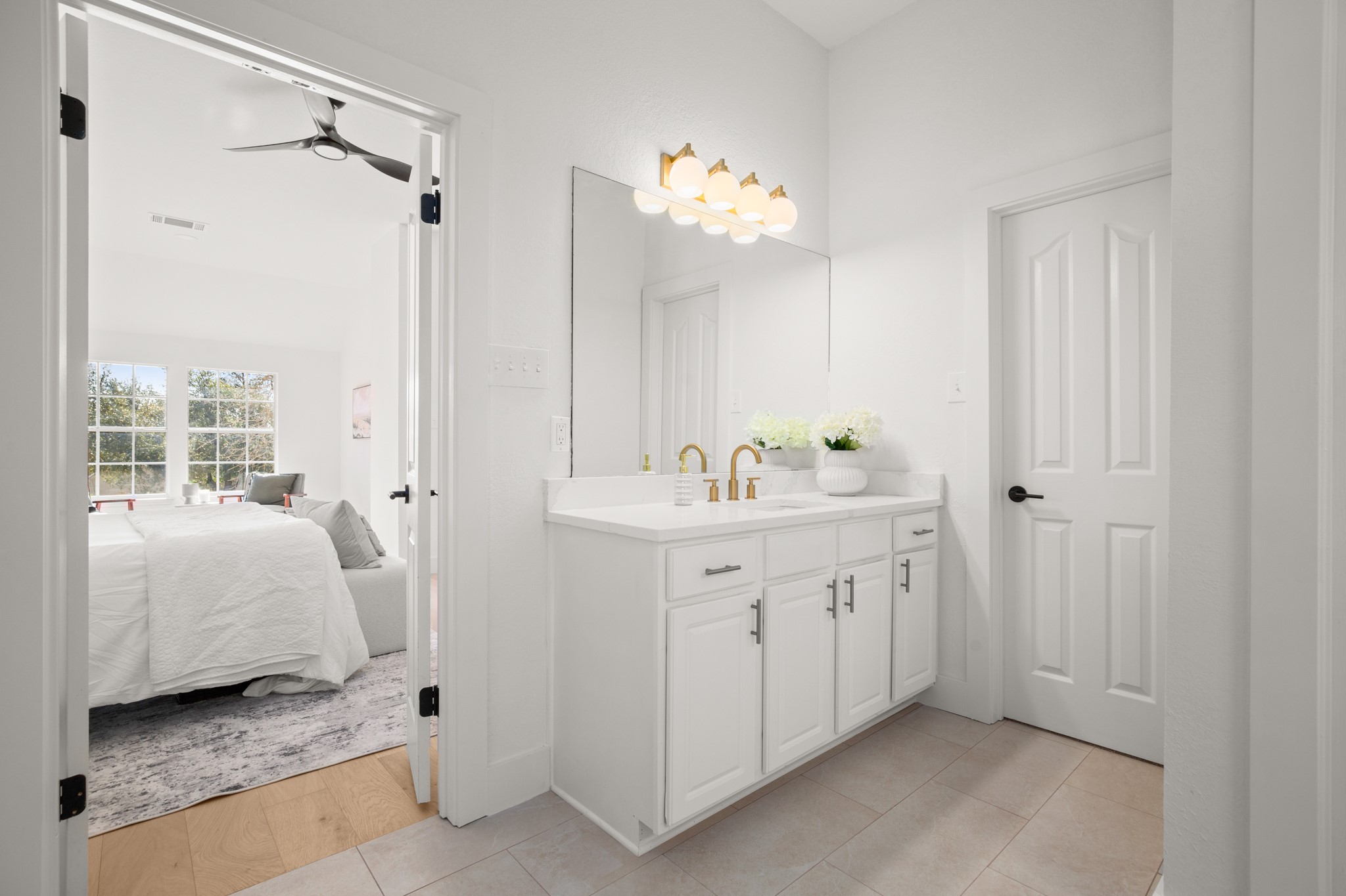 2022 Inverness Drive Round Rock, TX 78681 - Photo 25 of 38 a en suite bathroom with a double vanity sink a mirror and a shower