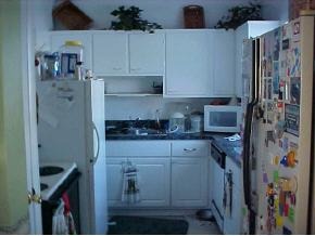 1066 Cable Palm Bay, FL 32905 - Photo 3 of 6 a kitchen with a refrigerator and cabinets