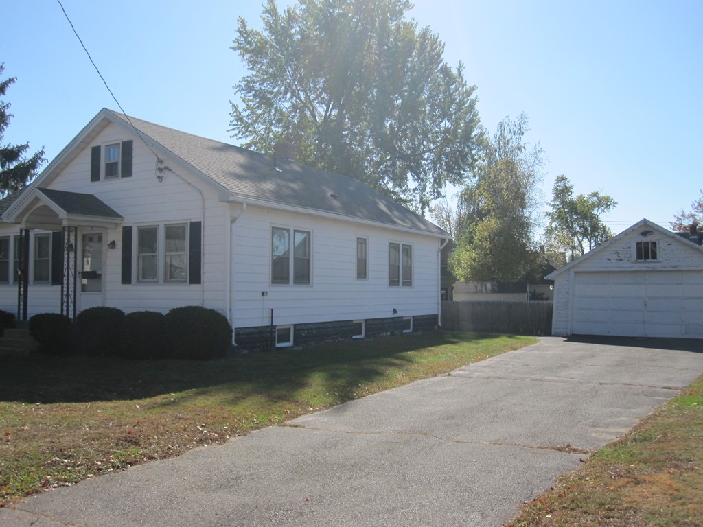 19 Nichols Street Springfield, MA 01151 - Photo 3 of 13 a front view of a house with a garden and trees