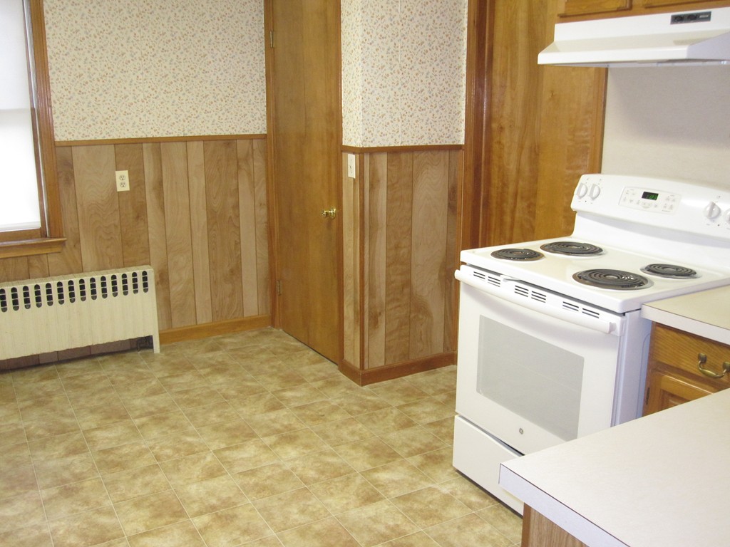 19 Nichols Street Springfield, MA 01151 - Photo 6 of 13 a kitchen with a stove and a cabinets