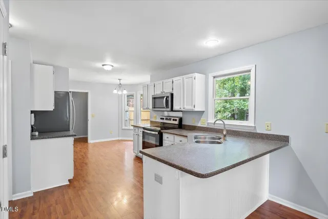 a kitchen with stainless steel appliances a refrigerator and a sink