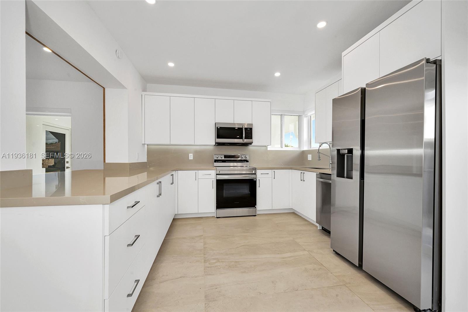 1511 Southwest 20th Court Miami, FL 33145 - Photo 13 of 41 a large kitchen with granite countertop white cabinets and stainless steel appliances