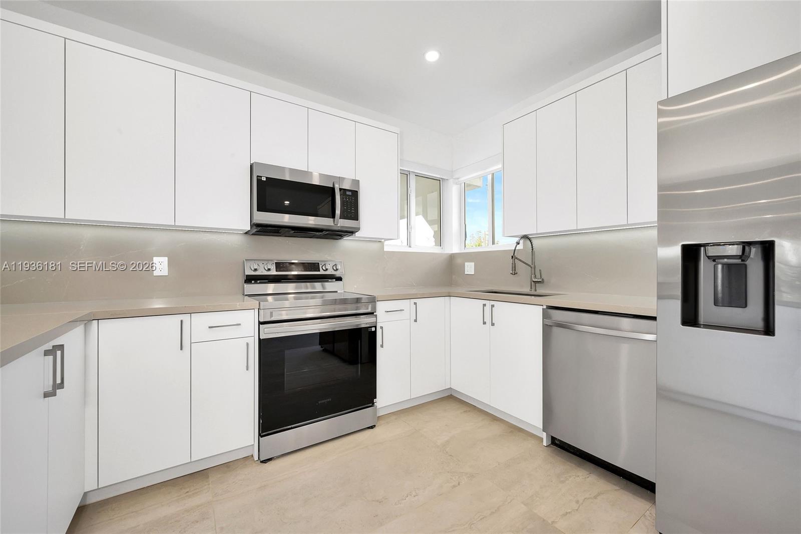 1511 Southwest 20th Court Miami, FL 33145 - Photo 14 of 41 a kitchen with granite countertop white cabinets and stainless steel appliances