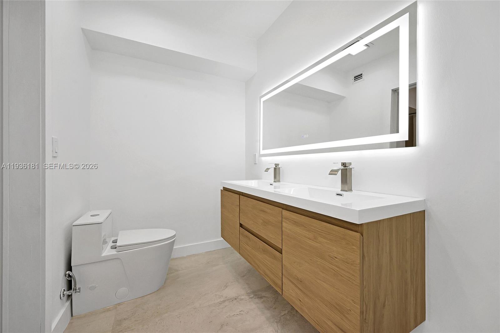 1511 Southwest 20th Court Miami, FL 33145 - Photo 34 of 41 a bathroom with a toilet sink and mirror