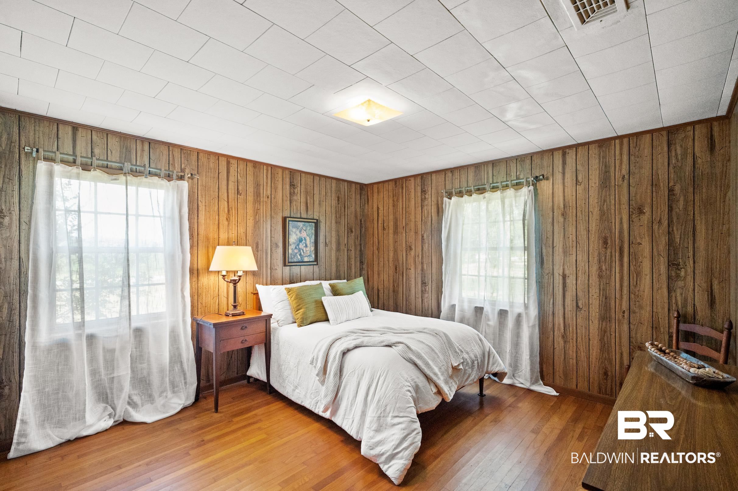 15600 Fackler Road Loxley, AL 36551 - Photo 17 of 51 Bedroom featuring wood walls and hardwood / wood-style flooring