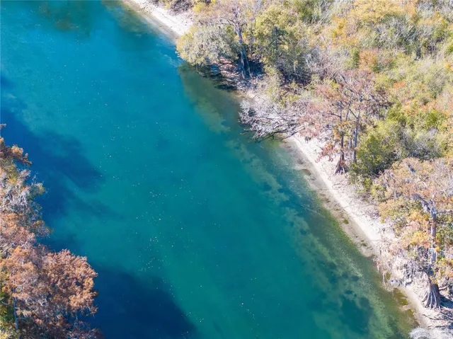 an aerial view of residential house and lake
