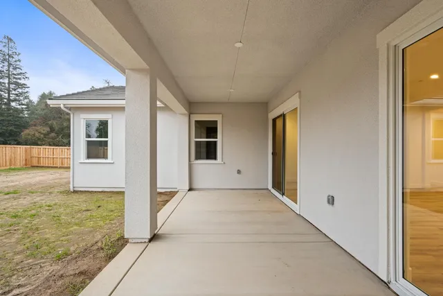 a view of a yard with wooden fence