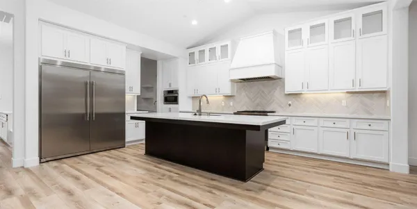 a kitchen with a sink stove and cabinets